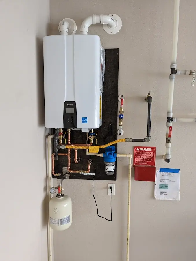 Professional plumber installing copper piping in a Henderson home